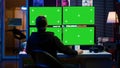 Cybercriminal coding on green screen monitors, developing zero day exploit Royalty Free Stock Photo