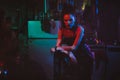 Cyberpunk girl in a post-apocalyptic futuristic style in a garage