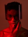 Cyberpunk, glasses and man in red studio, lighting, model and fashion in the future. Dark, tech and face portrait of