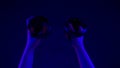 Cyberpunk hands playing vr blinking light closeup. Gamer arms using controllers