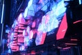 A cyberpunk-inspired high-rise building with an entire facade made from glowing hexagonal LED panels