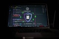 Cybersecurity concept with secure digital shield and lock icon over source code on laptop screen, representing data protection, Royalty Free Stock Photo