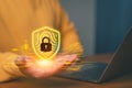 Cybersecurity concept showing a person holding a glowing digital shield with a padlock and fingerprint pattern Royalty Free Stock Photo