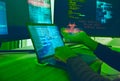 Cybersecurity, crime and hands of hacker with virus in neon office with code, fraud and danger. Software, ransomware and