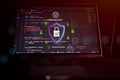 Cybersecurity and data protection concept showing secure digital shield and lock icon over programming code on laptop screen, Royalty Free Stock Photo