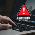 Cybersecurity and Data Risk Concept: A Person Using a Computer with an Unsafe Usage Warning on the Screen Royalty Free Stock Photo
