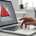 Cybersecurity and Data Risk Concept: A Person Using a Computer with an Unsafe Usage Warning on the Screen Royalty Free Stock Photo