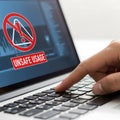 Cybersecurity and Data Risk Concept: A Person Using a Computer with an Unsafe Usage Warning on the Screen Royalty Free Stock Photo