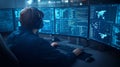 Cybersecurity expert analyzing data on multiple monitors Royalty Free Stock Photo