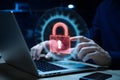 Cybersecurity expert with holographic pad displaying red open padlock