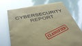 Cybersecurity report classified, seal stamped on folder with important documents Royalty Free Stock Photo