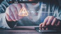 Cybersecurity threat concept. A person uses a smartphone and interacts with a holographic interface displaying a system warning, Royalty Free Stock Photo