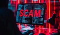 Cybersecurity threat concept with the word SCAM in bold red letters on a computer screen, signifying internet fraud, hacking