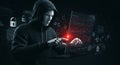 Cybersecurity threats: robot hacker manipulating data on a laptop in a dark environment
