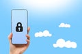Cyberspace and online security. A female hand holds a smartphone with lock. Light blue background. Copy space. Cloud Royalty Free Stock Photo