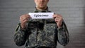 Cyberwar word written on sign in hands of male soldier, information security Royalty Free Stock Photo