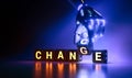 Cyborg robot hand changes text cube from change to chance - ai concept