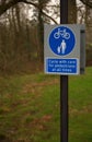 Cycle with care sign on country path.