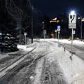 Cycle path covered in snow with signs at night Royalty Free Stock Photo