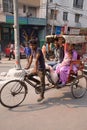 Cycle rickshaw carrying passengers in New Delhi, India