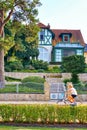 Cycle rider on the beach promenade in Zinnowitz on the island of Usedom. Resort architecture in the background Royalty Free Stock Photo