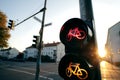 A cycle traffic light shows red and yellow light at an european intersection in uplifting and inspiring morning light