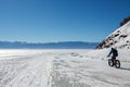 Cycler on the ice of Baikal lake Royalty Free Stock Photo