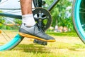 Cycler`s foot on pedal bicycle in  park at summer Royalty Free Stock Photo