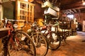 Cycles and retro bikes for sale inside antique store with many vintage utensil, decor, wooden furniture