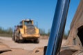 A cyclinder of a digger arm with a industrial vehicle in the background Royalty Free Stock Photo