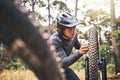 Cycling, adventure trail and bike repair, man fix wheel in forest. Nature, mountain biking and cyclist, outdoor cycle Royalty Free Stock Photo