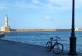 Cycling Around the Old Port of Chania with the Historic Lighthouse, Crete Island, Greece Royalty Free Stock Photo