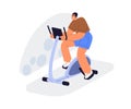 Cycling bike machine in gym. Person training endurance on stationary bicycle trainer, simulator. Happy man doing cardio Royalty Free Stock Photo