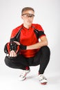 Cycling Concepts. Portrait of Professional Cyclist Posing Equipped in Glasses and With Helmet Against White Royalty Free Stock Photo