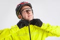 Cycling Concepts. Portrait of Professional Cyclist Posing Equipped in Green Jacket With Glasses and Helmet Against White Royalty Free Stock Photo