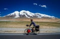 Cycling in front of Muztagh Ata Royalty Free Stock Photo