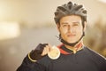 Cycling, helmet and medal with a sports man after a race as a winner, champion or medalist outside. Motivation Royalty Free Stock Photo