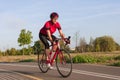 Cycling Ideas. One Emotional Male Cyclist Riding Road Bike Uphill Equipped with Summer Bike Outfit Posing Outdoor During Training Royalty Free Stock Photo