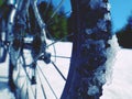 Cycling on large tyres in fresh snow. Biker goes by bike on the snowy road Royalty Free Stock Photo