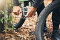 Cycling, maintenance and hands of man with mountain bike fix, service or repair wheel gear, chain or tire equipment Royalty Free Stock Photo