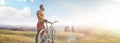 Cycling. Man with bike on a forest road in the mountains on a summer day. Mountain valley during sunrise. Panorama Royalty Free Stock Photo