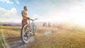 Cycling. Man with bike on a forest road in the mountains on a summer day. Mountain valley during sunrise. Sport Royalty Free Stock Photo