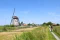 Cycling on narrow bike path along ancient windmills