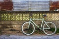 Bike and old fence cement with corrugated iron which as the background. Royalty Free Stock Photo