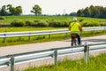 Cycling outdoor Ã¢â¬â elderly woman in a yellow vest riding a bicycle