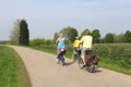 Cycling tourists in spring at the touristic Appeldijk (Apple Dike),Betuwe,Holland