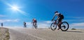 Cycling race on an uphill road in Ioannina, Greece, four bikers and bikes  sun Royalty Free Stock Photo