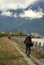 Cycling by the riverside in deep tibet valley Royalty Free Stock Photo