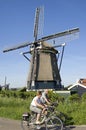 Cycling seniors and historic windmill