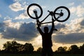 Cycling silhouette rider with bicycle holding up